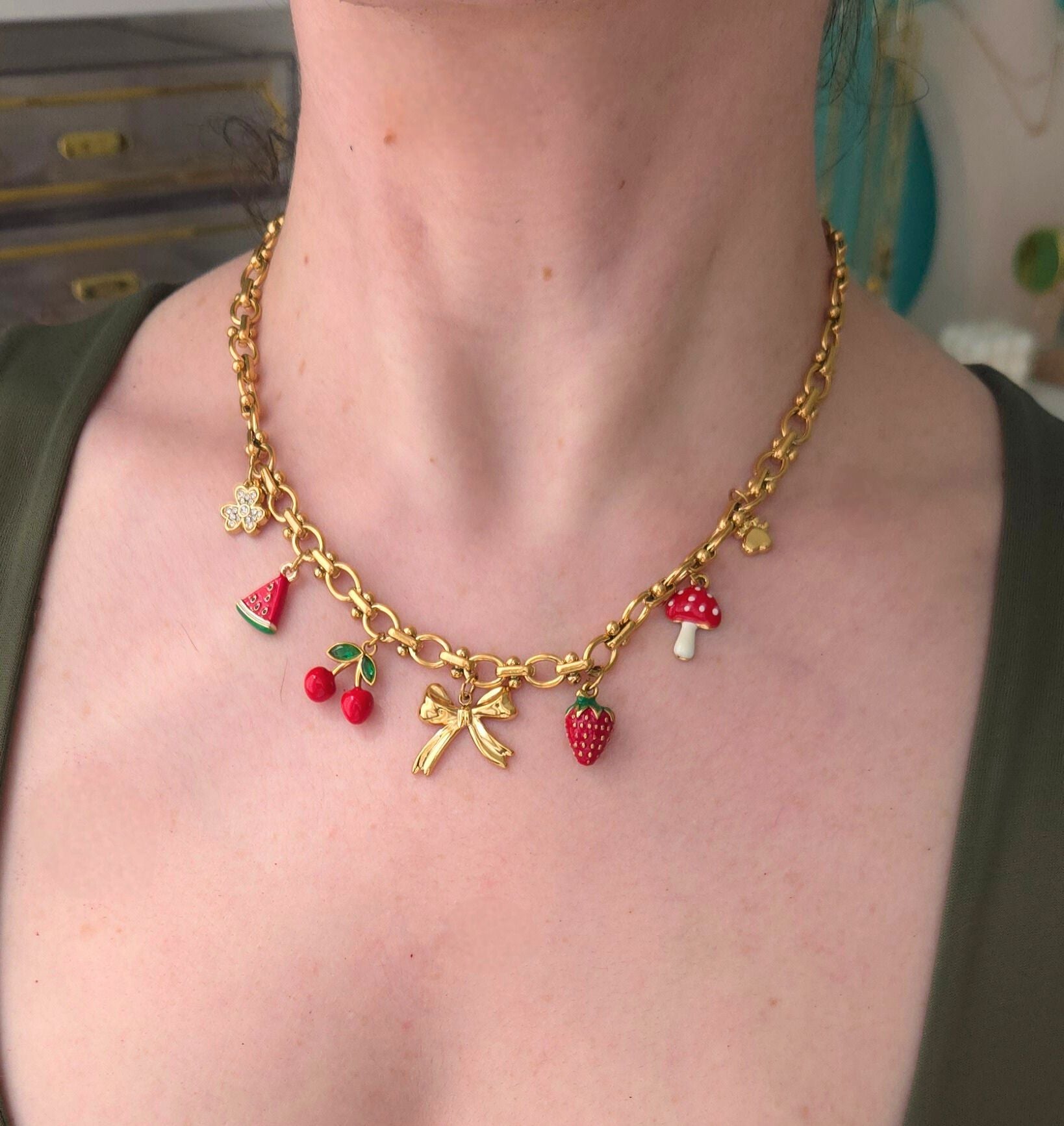 Gold necklace with colorful charms 